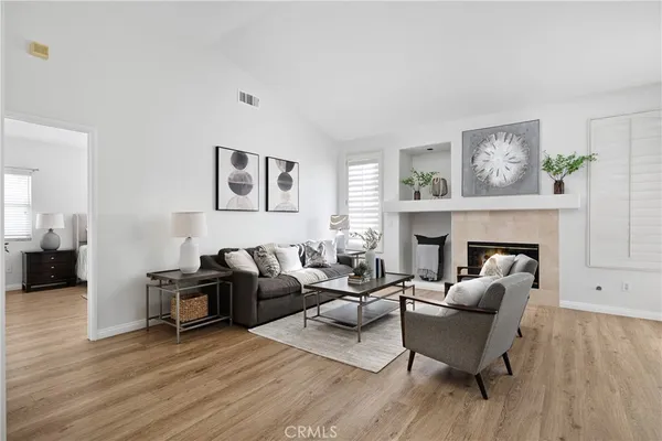 a living room with furniture and a fireplace