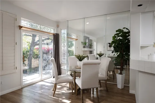 a dining room with furniture window and wooden floor