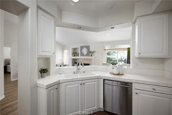 a kitchen with a sink cabinets and window
