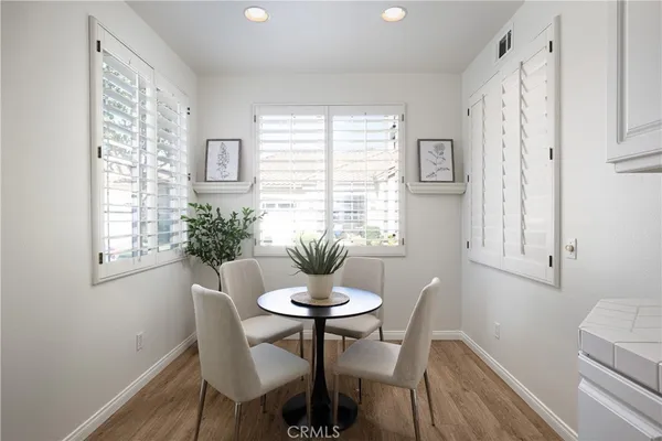 a dining room with furniture and window