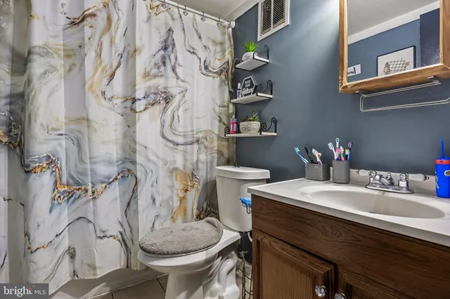 a bathroom with a sink and mirror with toilet