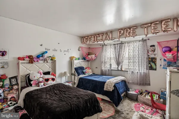 a bedroom with two beds and a window