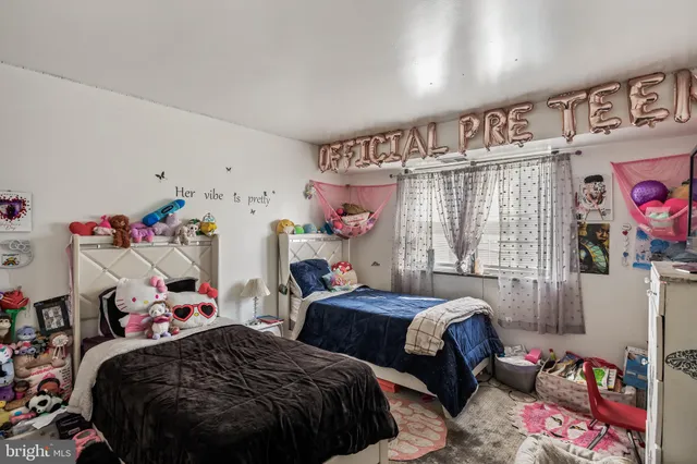 a bedroom with two beds and a window