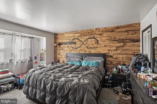 a bed sitting in a bedroom next to a window