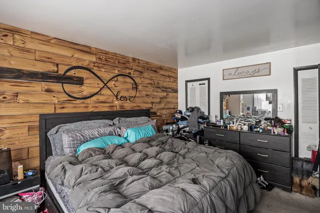 a bedroom with a bed and ceiling fan