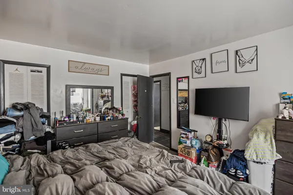 a bedroom with furniture and a flat screen tv