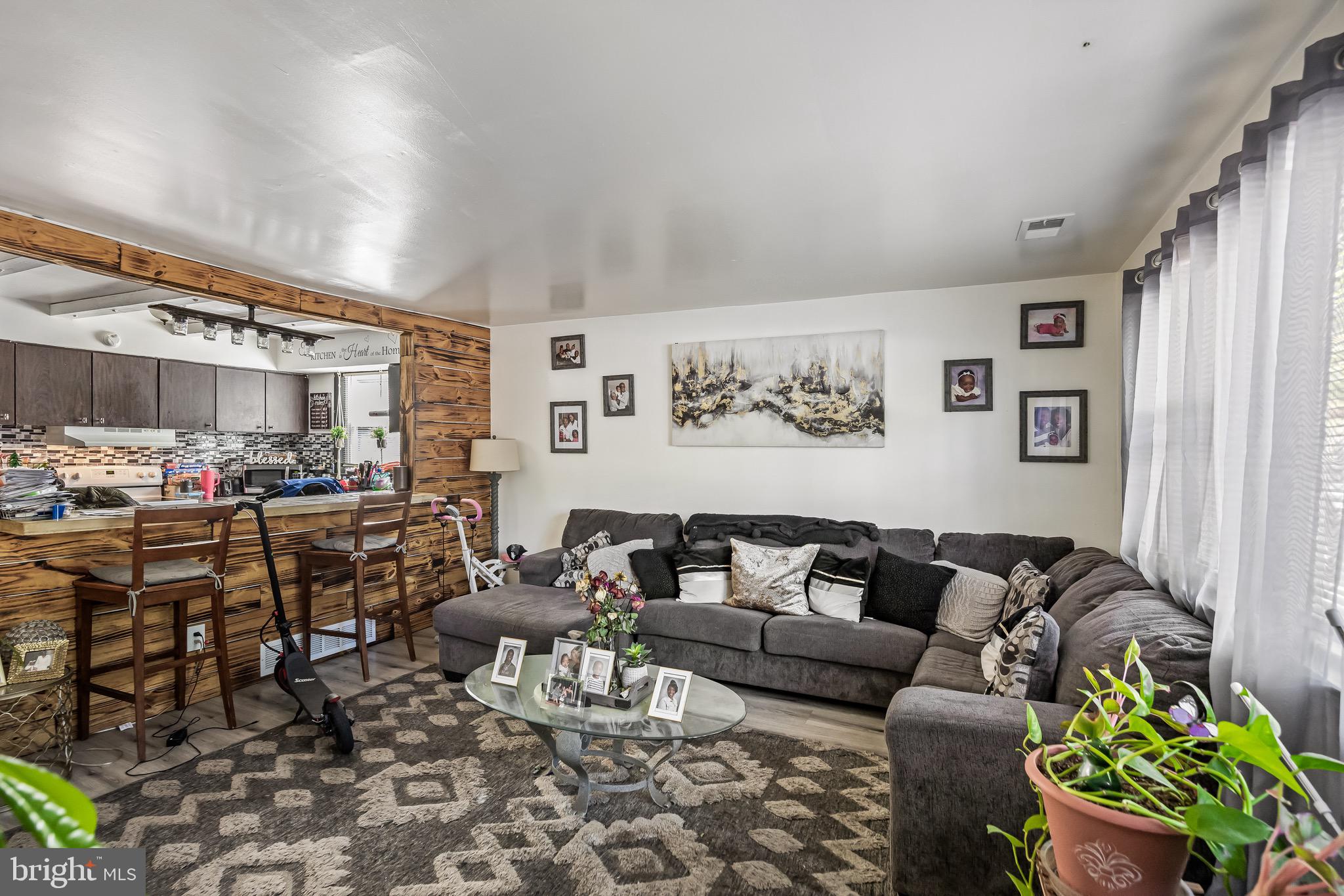 1294 Cooper Street, Unit E13 Edgewater Park, NJ 08010 - Photo 4 of 15 a living room with furniture and a large window