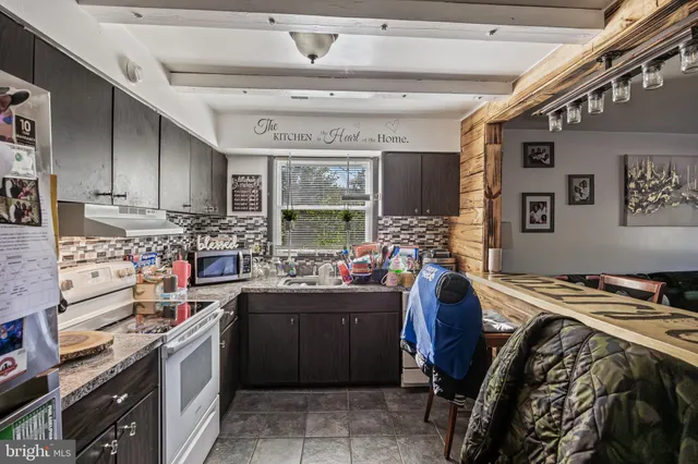a kitchen with a sink a stove and cabinets