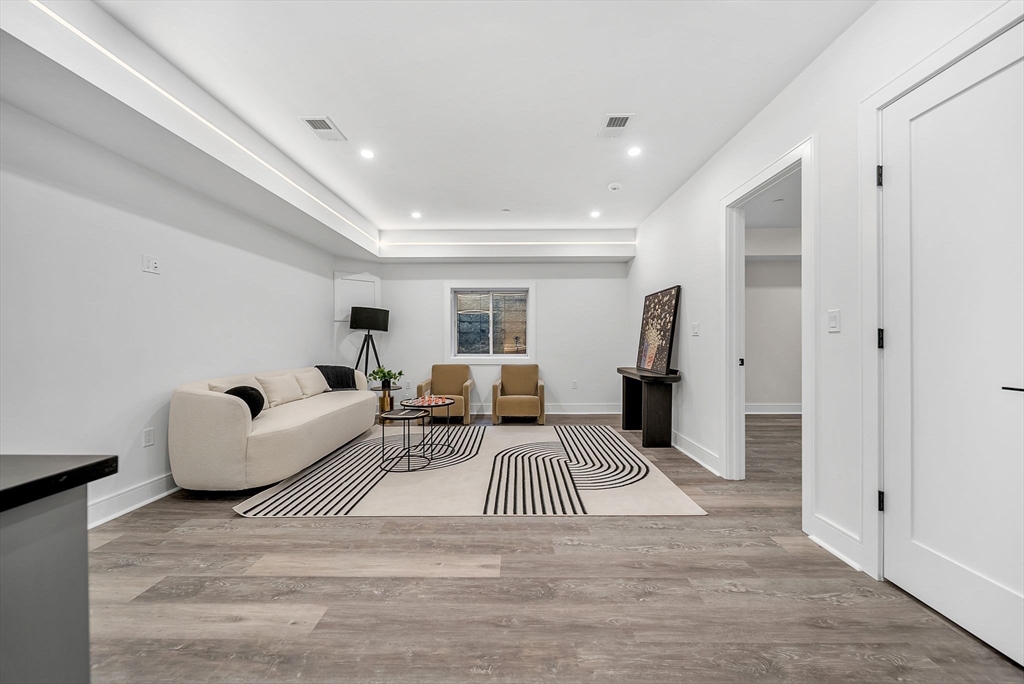 284 Nevada Street, Unit 284 Newton, MA 02460 - Photo 20 of 29 a living room with furniture and a wooden floor