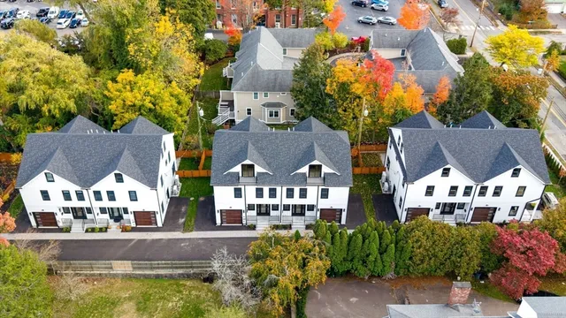 an aerial view of residential houses with yard and swimming pool