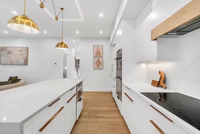 a hallway with a sink and cabinets