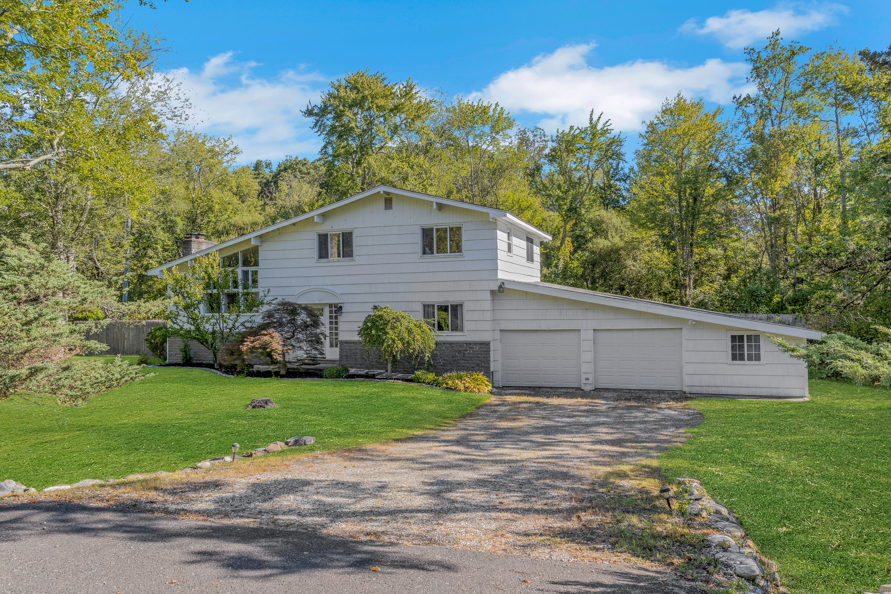 Contemporary Split-Level on .76 acre level, corner lot.