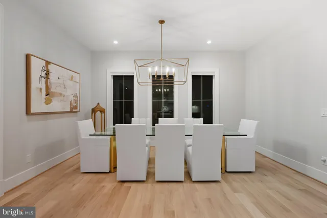 a view of kitchen with stainless steel appliances granite countertop a stove and a wooden floors