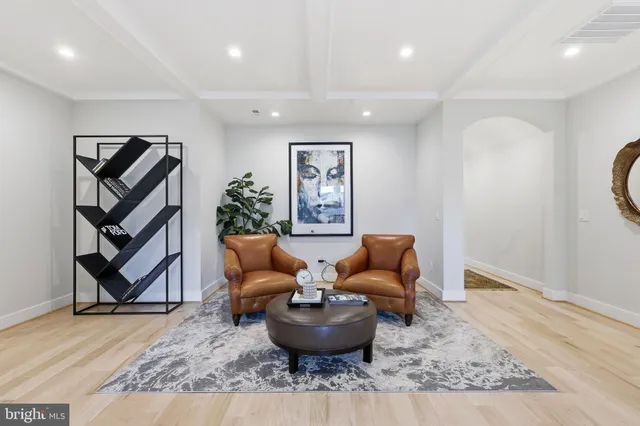 a living room with furniture and a painting
