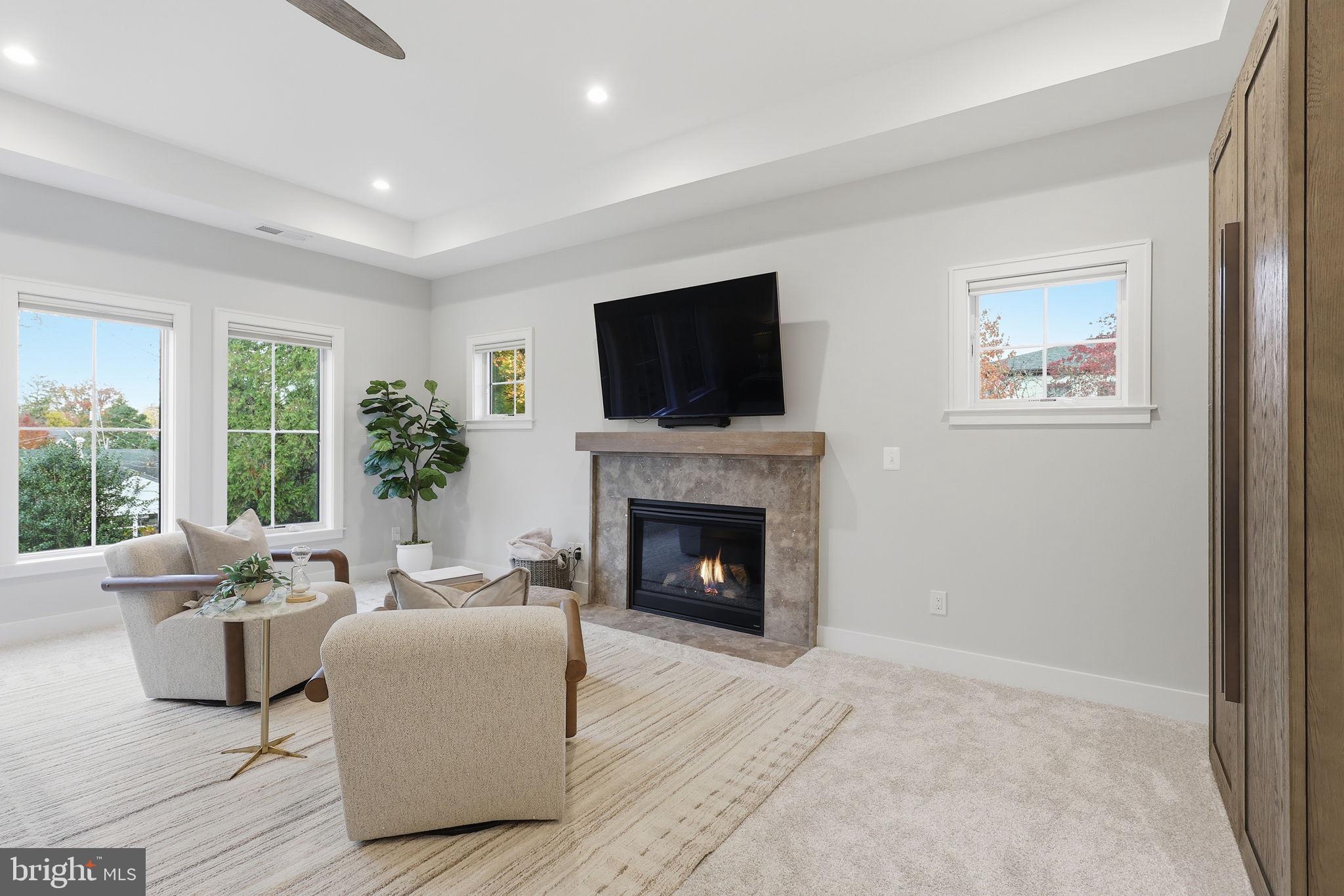 7000 Hector Road McLean, VA 22101 - Photo 22 of 50 a living room with furniture a flat screen tv and a fireplace