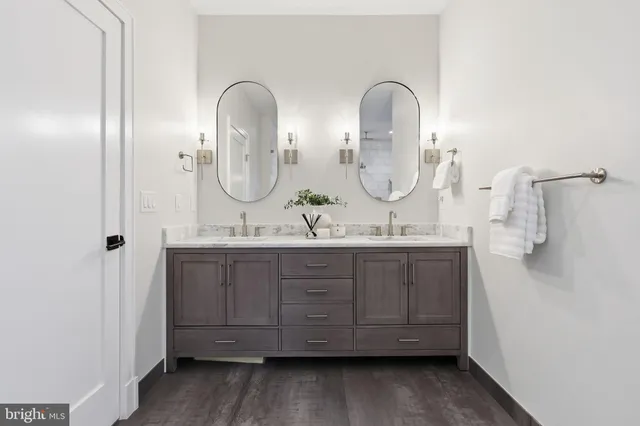 a en suite bathroom with a sink double vanity and a mirror