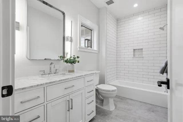 a spacious bedroom with a bed and wooden floor