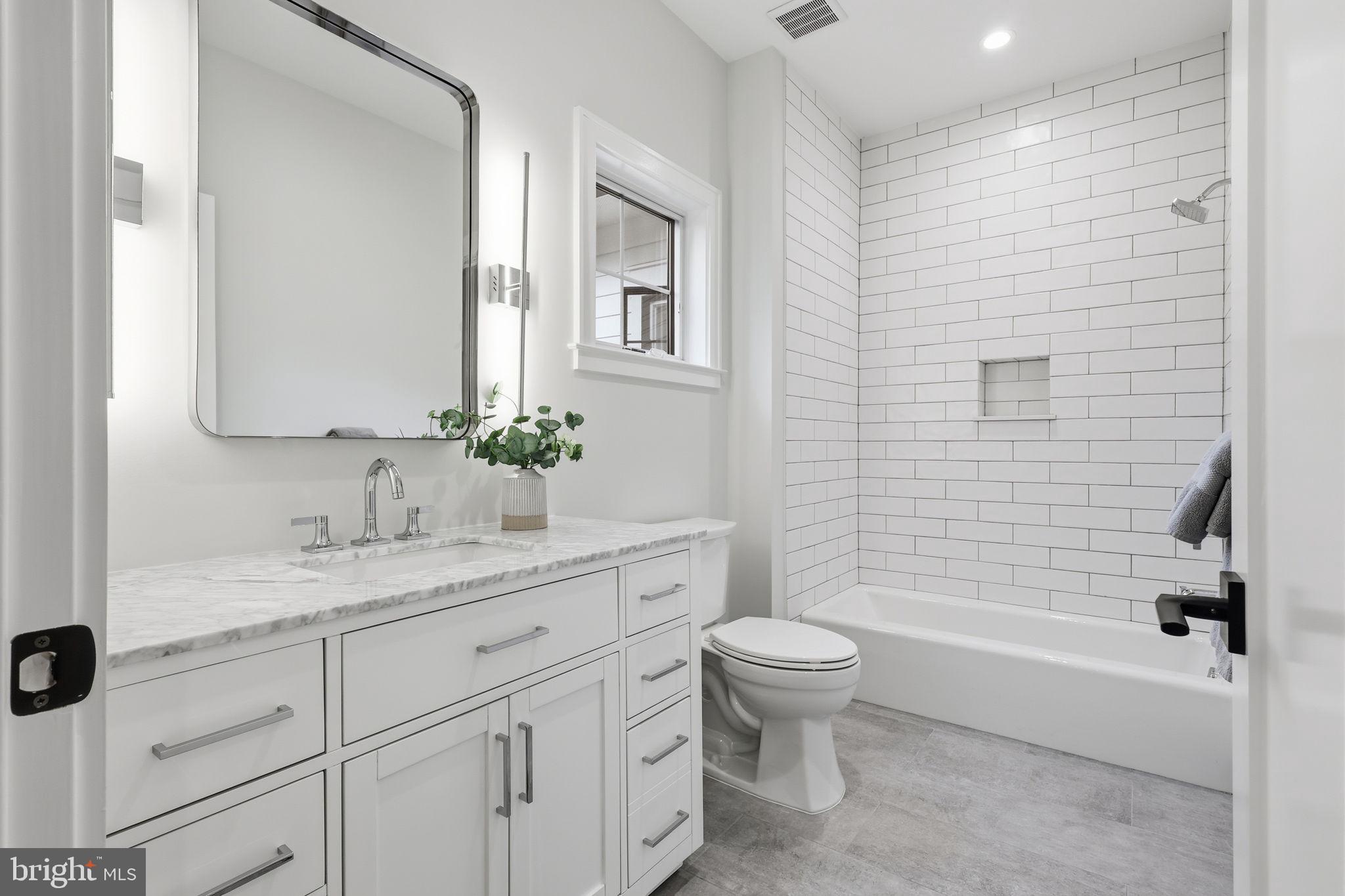 7000 Hector Road McLean, VA 22101 - Photo 31 of 50 a bathroom with a granite countertop sink toilet and shower