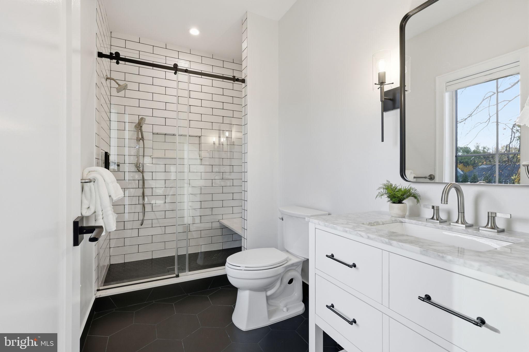 7000 Hector Road McLean, VA 22101 - Photo 35 of 50 a bathroom with a double vanity sink toilet and shower