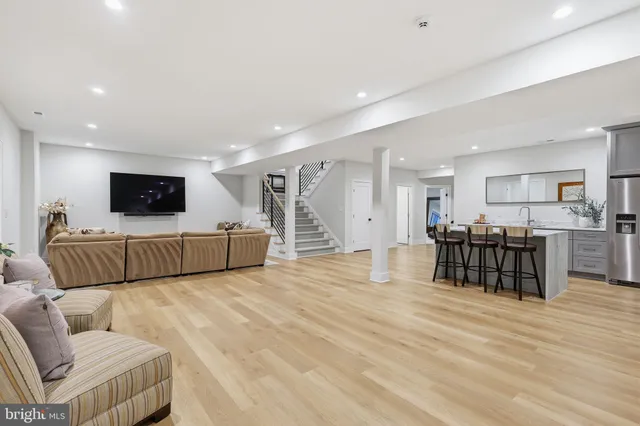 a kitchen with stainless steel appliances kitchen island hardwood floor sink and stove