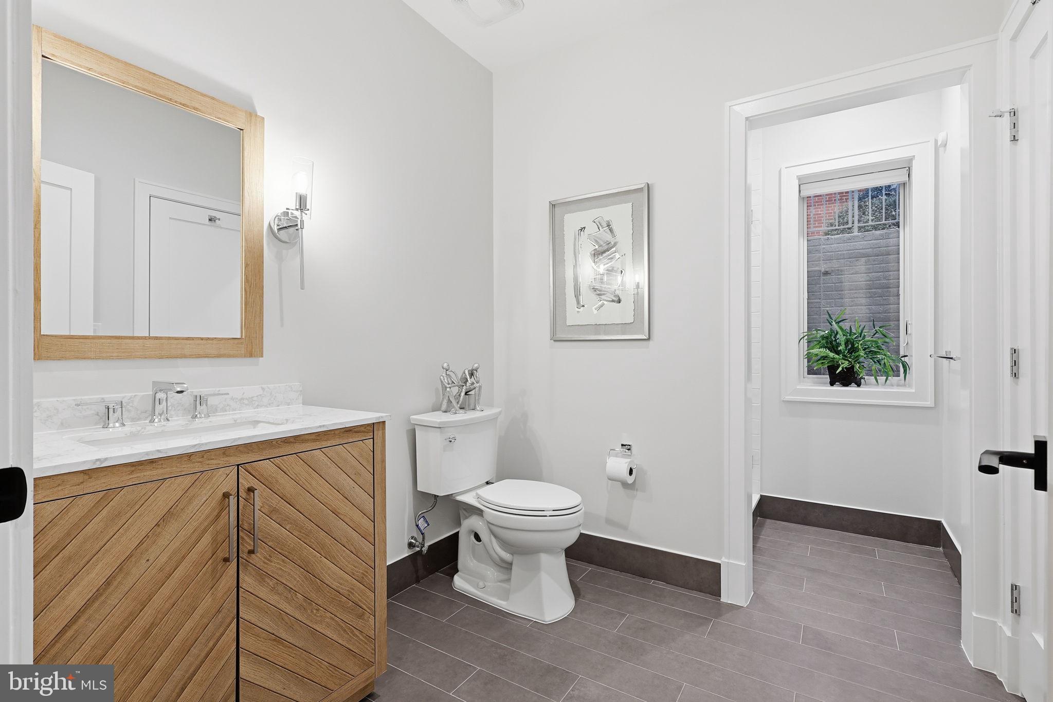 7000 Hector Road McLean, VA 22101 - Photo 41 of 50 a bathroom with a toilet sink and mirror