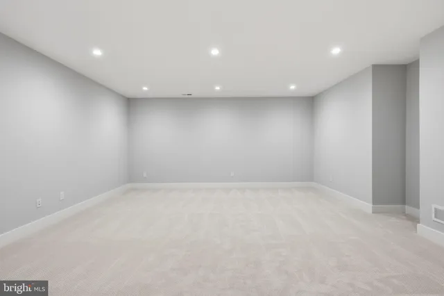 a bathroom with a granite countertop sink mirror vanity and toilet