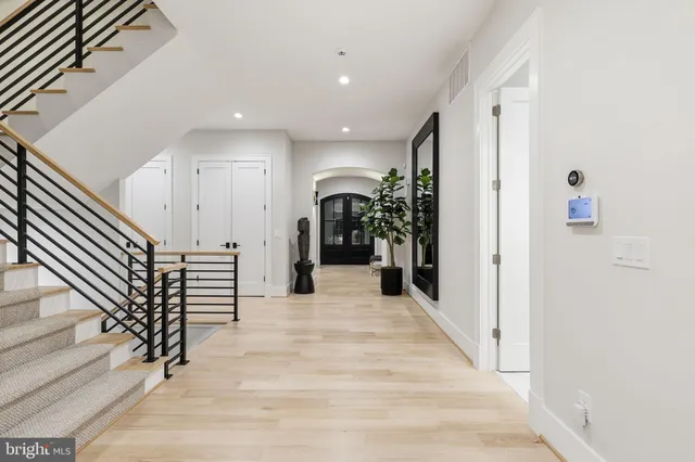 a view of a hallway with wooden floor and entryway