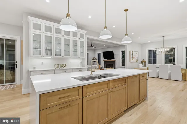 a kitchen with stainless steel appliances granite countertop a sink a oven and a wooden floors