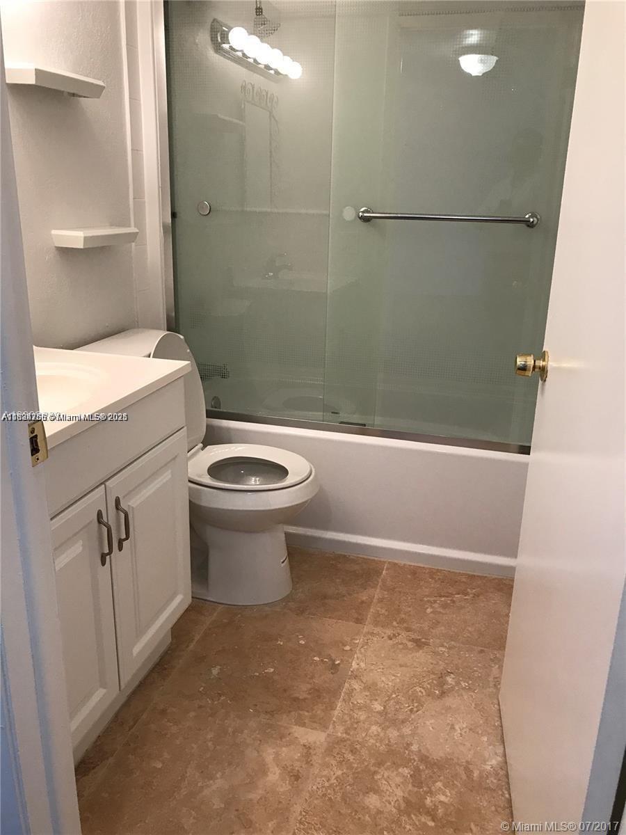 10288 Northwest 9th St Circle, Unit 205 Miami, FL 33172 - Photo 1 of 11 a bathroom with a toilet and a shower