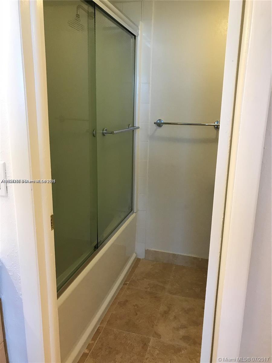 10288 Northwest 9th St Circle, Unit 205 Miami, FL 33172 - Photo 11 of 11 a bathroom with a glass shower door