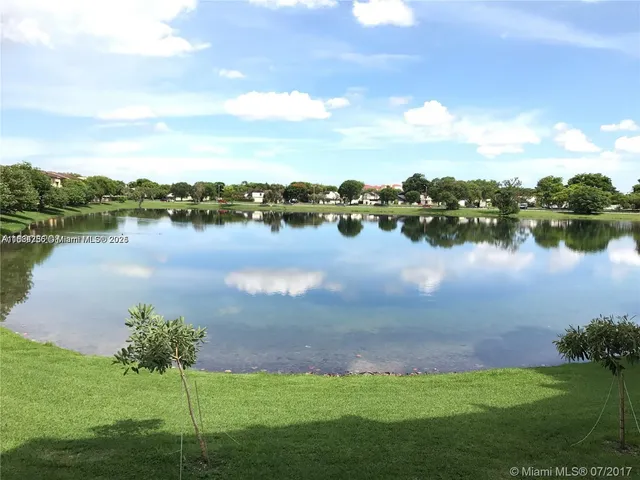 a view of a lake with houses in the back