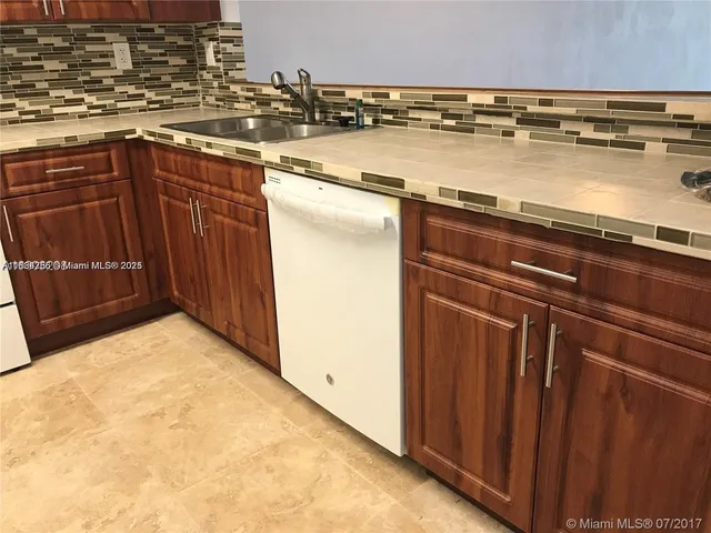 a view of a kitchen with wooden floor