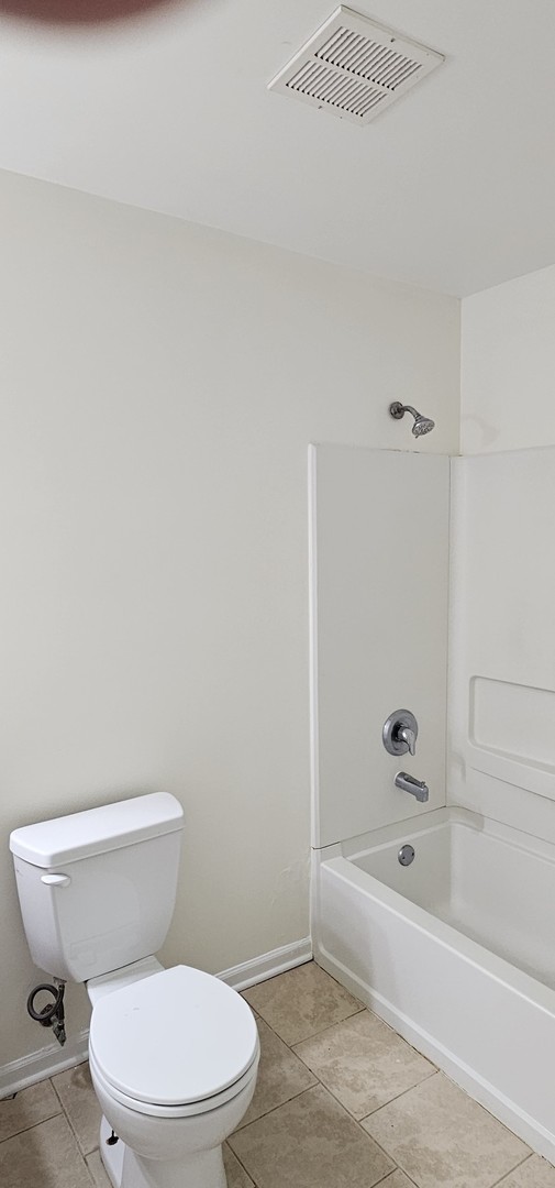 833 Village Quarter Road, Unit A3 West Dundee, IL 60118 - Photo 24 of 27 a white toilet and tub sitting next to a bathroom sink