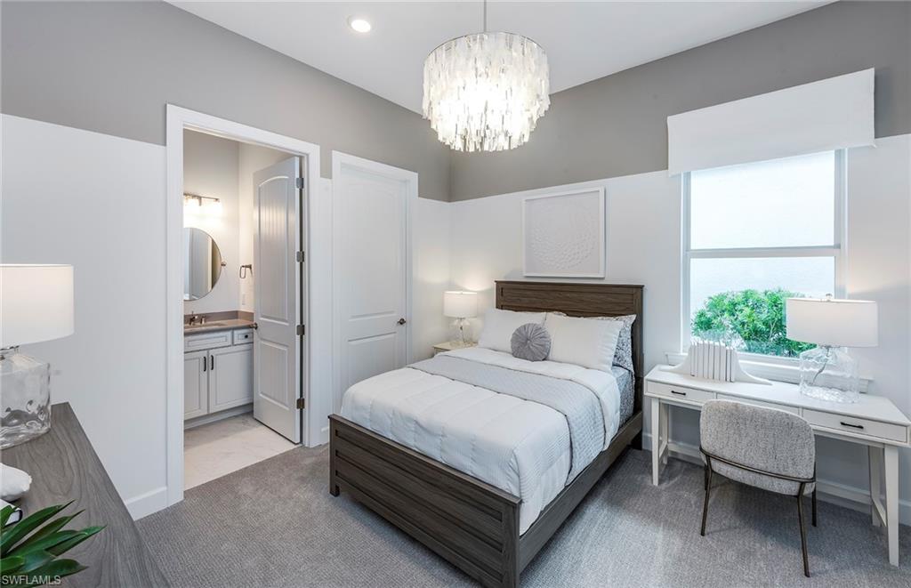 20619 Napa Loop Estero, FL 33928 - Photo 13 of 37 a bedroom with a bed and a chandelier