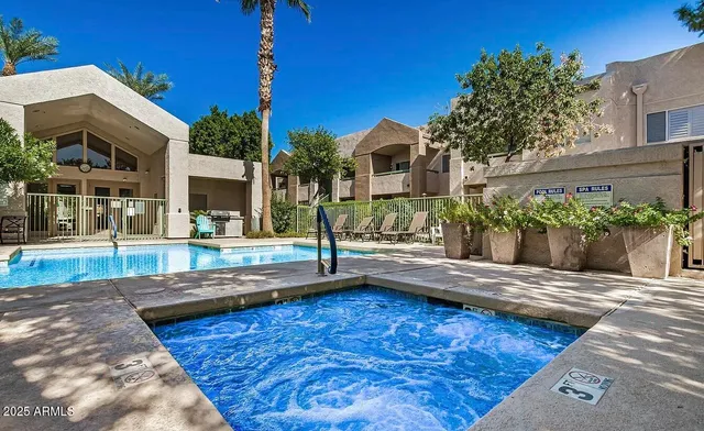 a view of a patio with table and chairs and potted plants