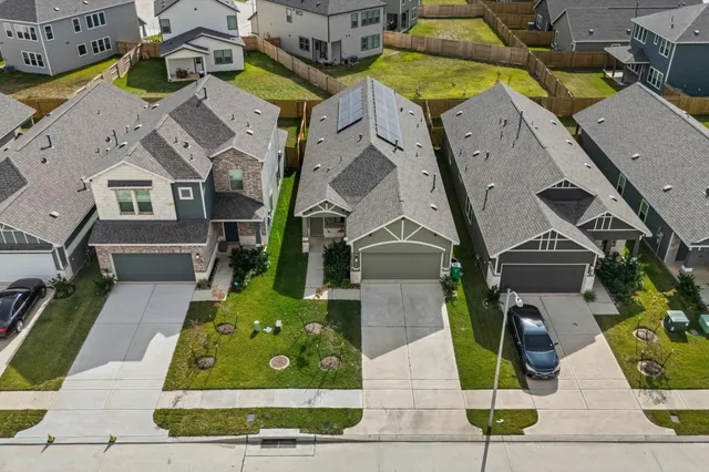 an aerial view of residential houses with outdoor space