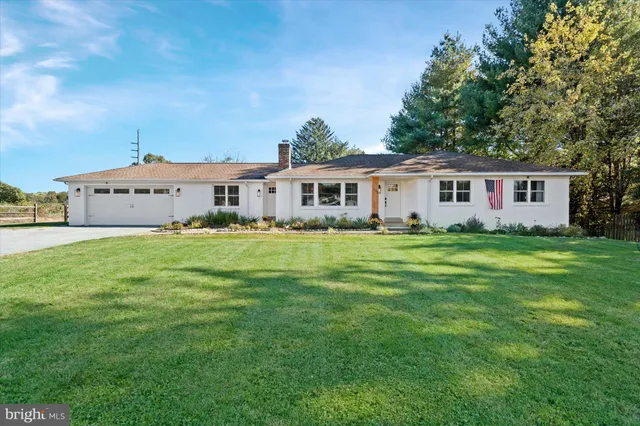 a front view of house with yard and green space