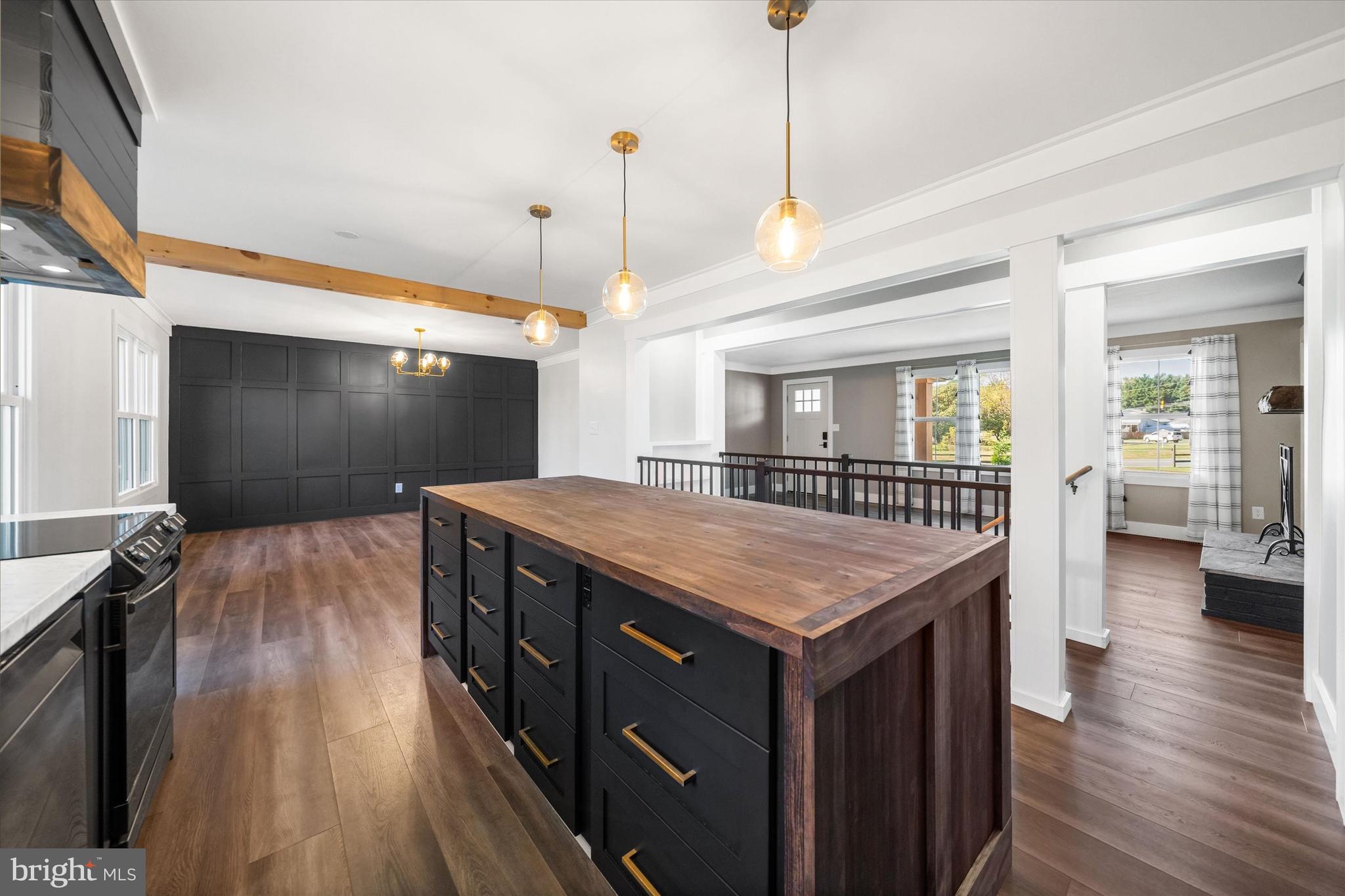 108 Evanson Road Hockessin, DE 19707 - Photo 11 of 49 a kitchen with a stove center island wooden floor and a ceiling fan
