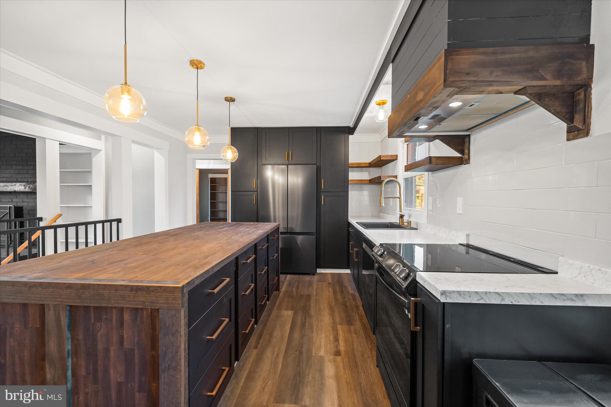 108 Evanson Road Hockessin, DE 19707 - Photo 12 of 49 a kitchen with stainless steel appliances granite countertop a sink a stove and a wooden floors