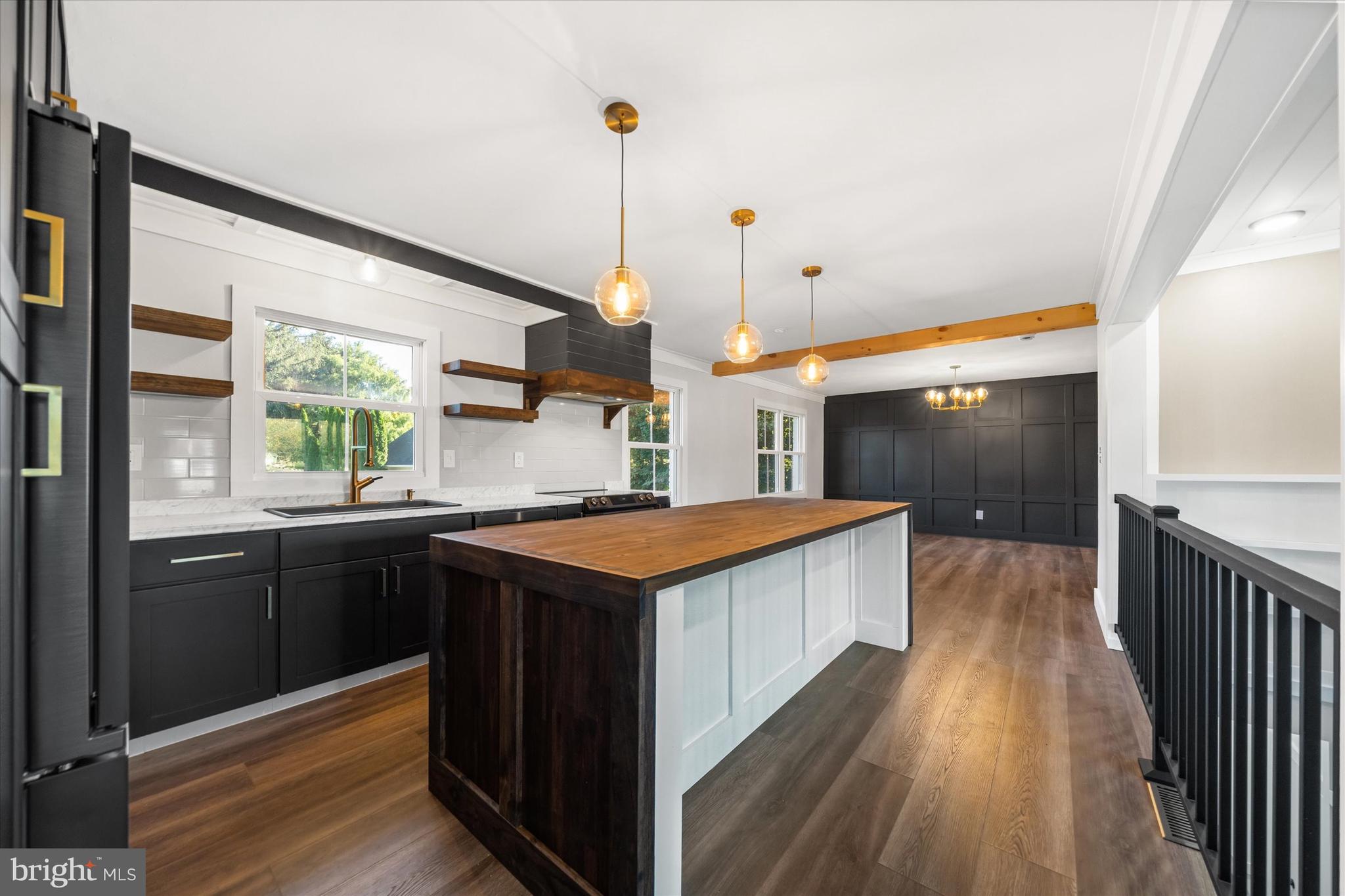 108 Evanson Road Hockessin, DE 19707 - Photo 13 of 49 a kitchen with kitchen island a sink a stove and a wooden floor