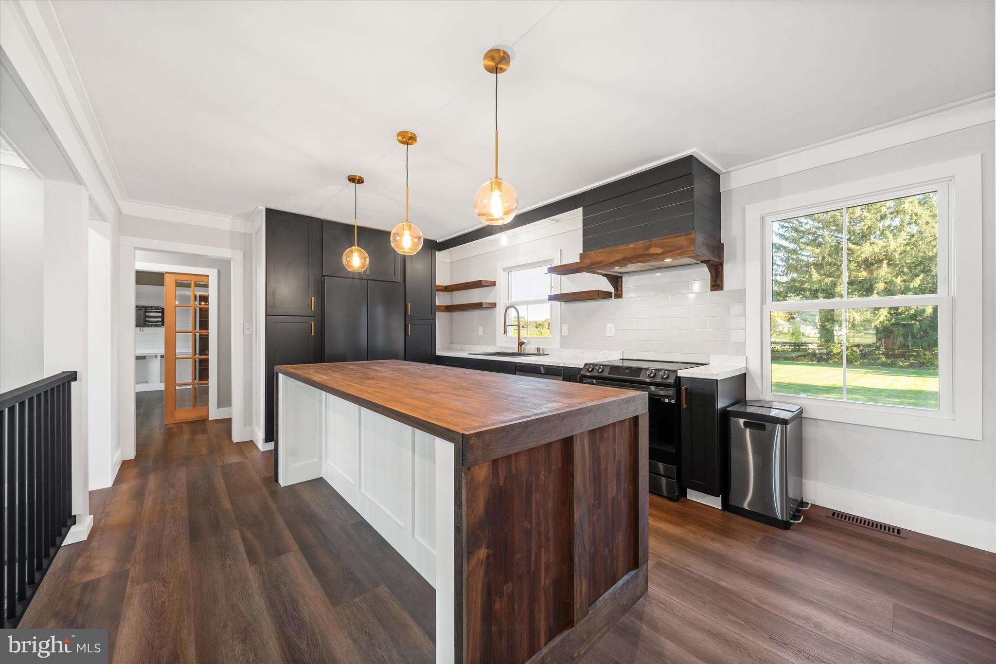 108 Evanson Road Hockessin, DE 19707 - Photo 14 of 49 a kitchen with stainless steel appliances granite countertop a stove and a wooden floors