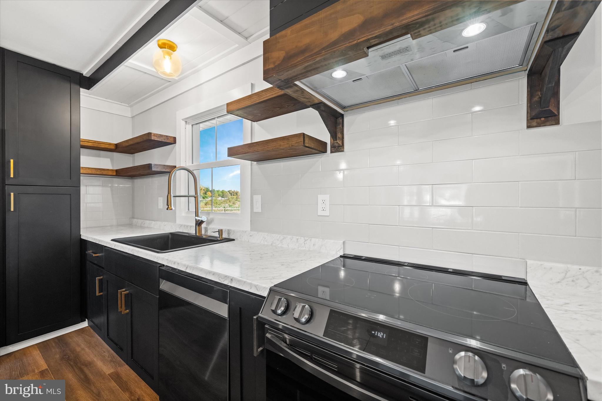 108 Evanson Road Hockessin, DE 19707 - Photo 15 of 49 a kitchen with a stove and a microwave