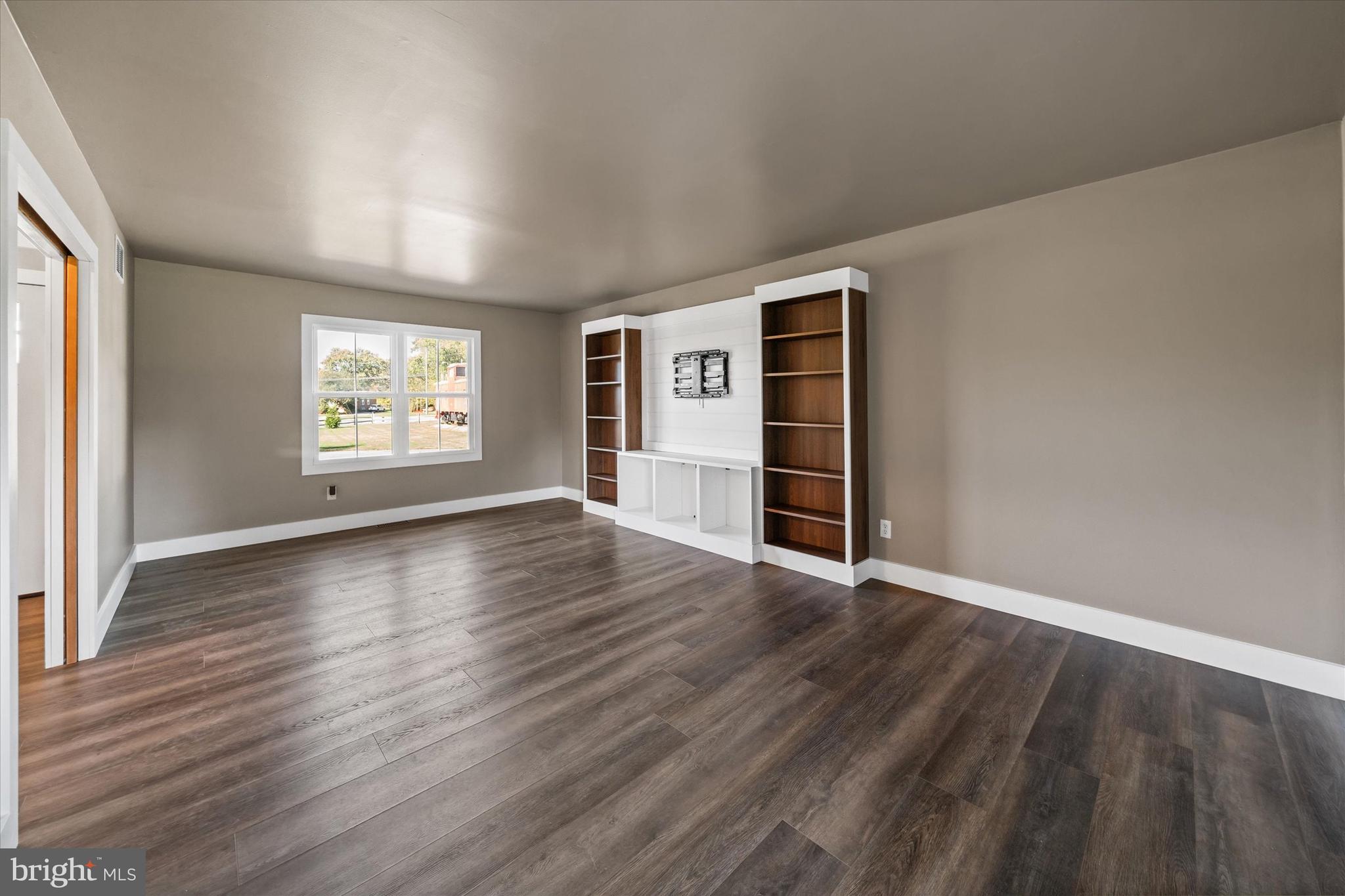 108 Evanson Road Hockessin, DE 19707 - Photo 23 of 49 an empty room with wooden floor and windows