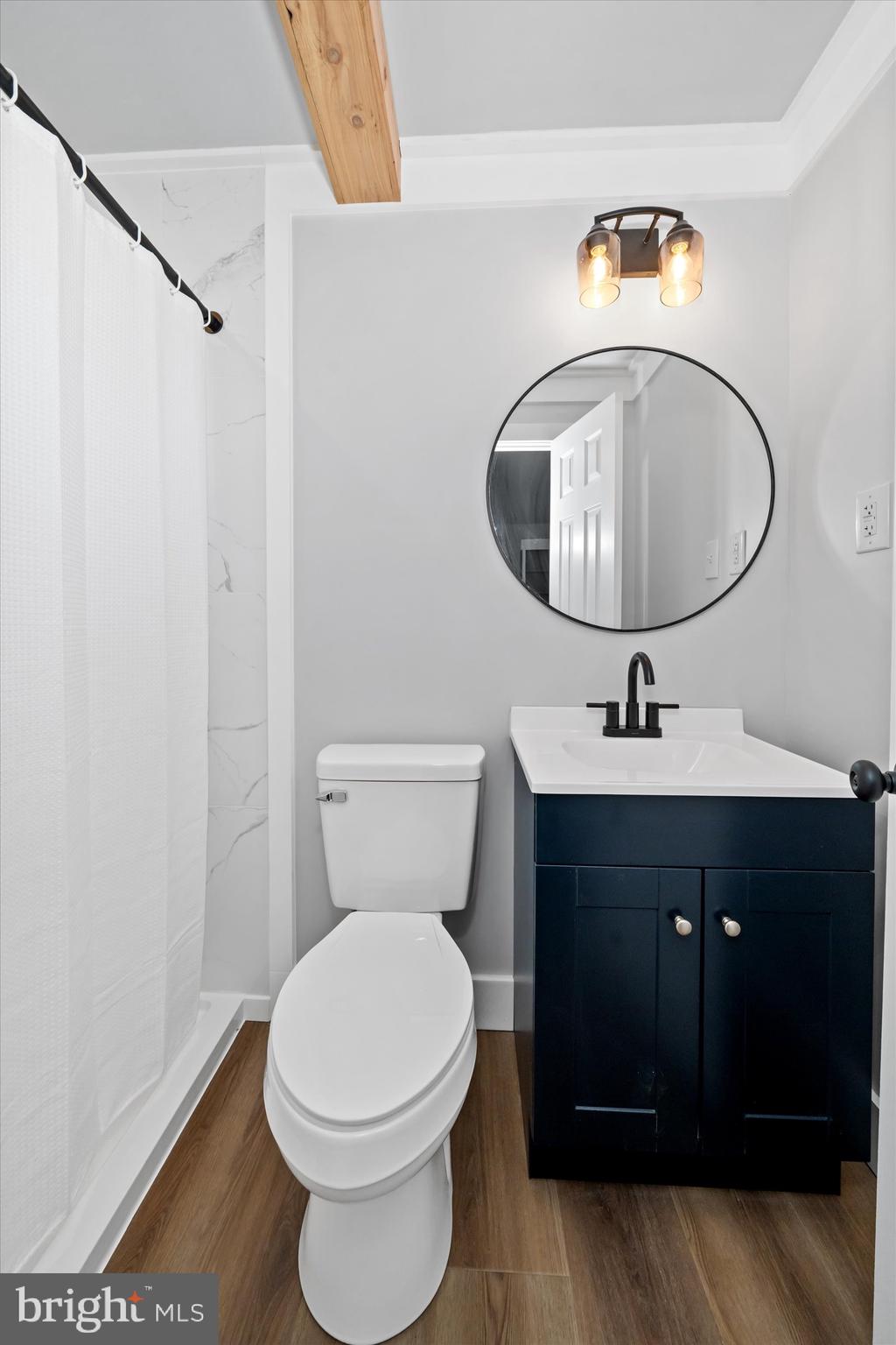 108 Evanson Road Hockessin, DE 19707 - Photo 25 of 49 a bathroom with a granite countertop toilet sink and mirror