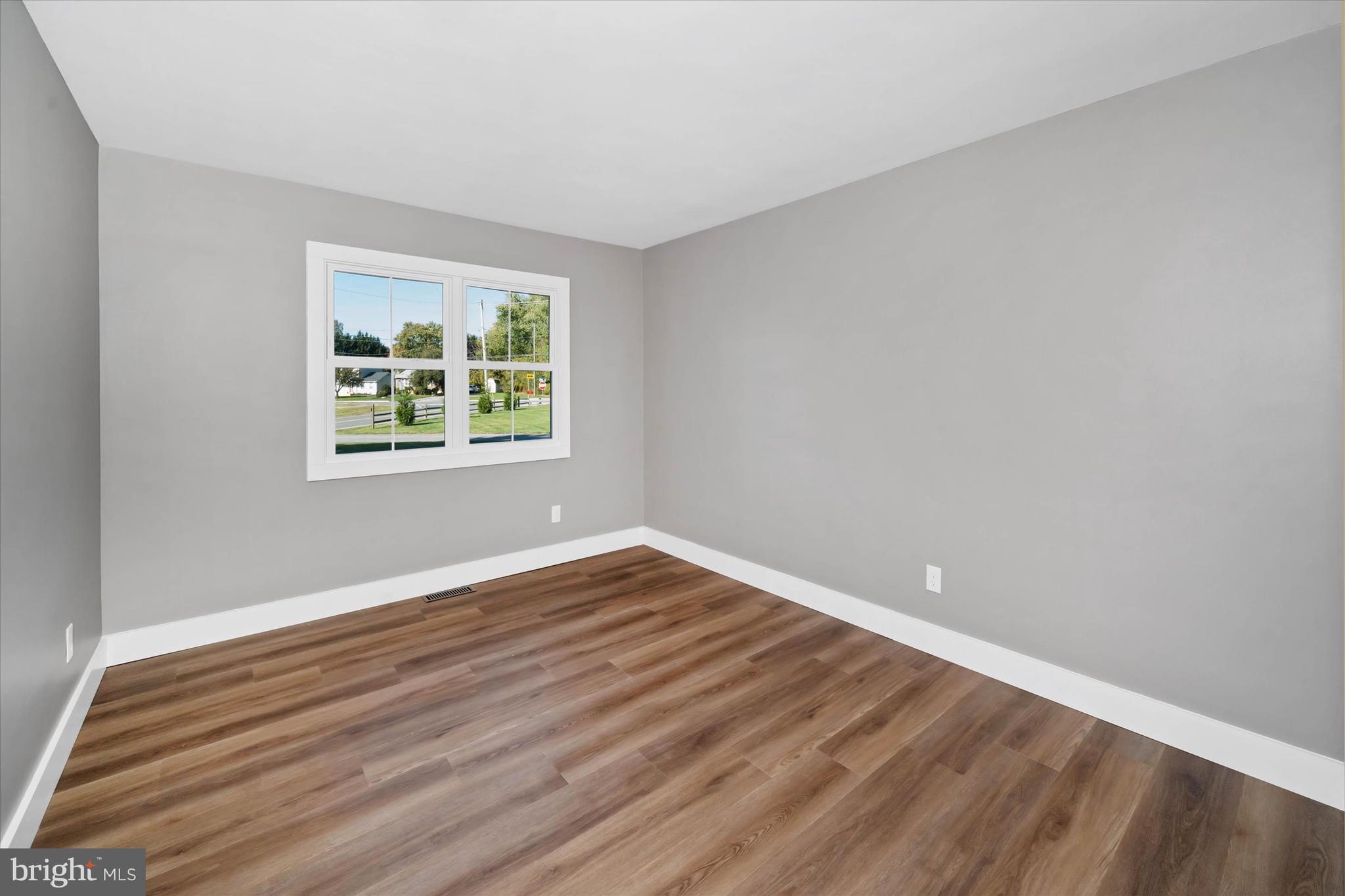 108 Evanson Road Hockessin, DE 19707 - Photo 32 of 49 a view of an empty room with wooden floor and a window