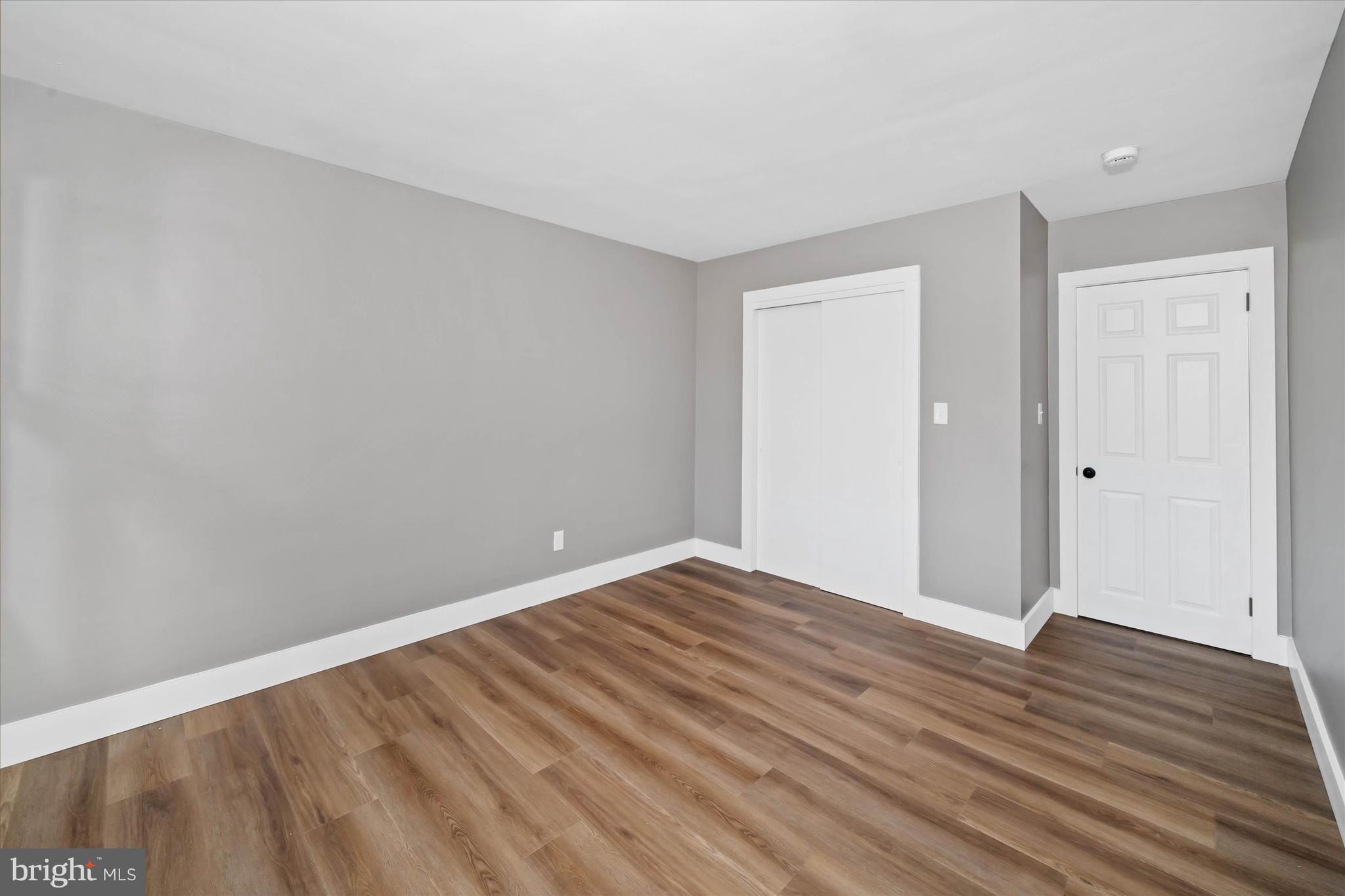 108 Evanson Road Hockessin, DE 19707 - Photo 33 of 49 a view of an empty room with wooden floor