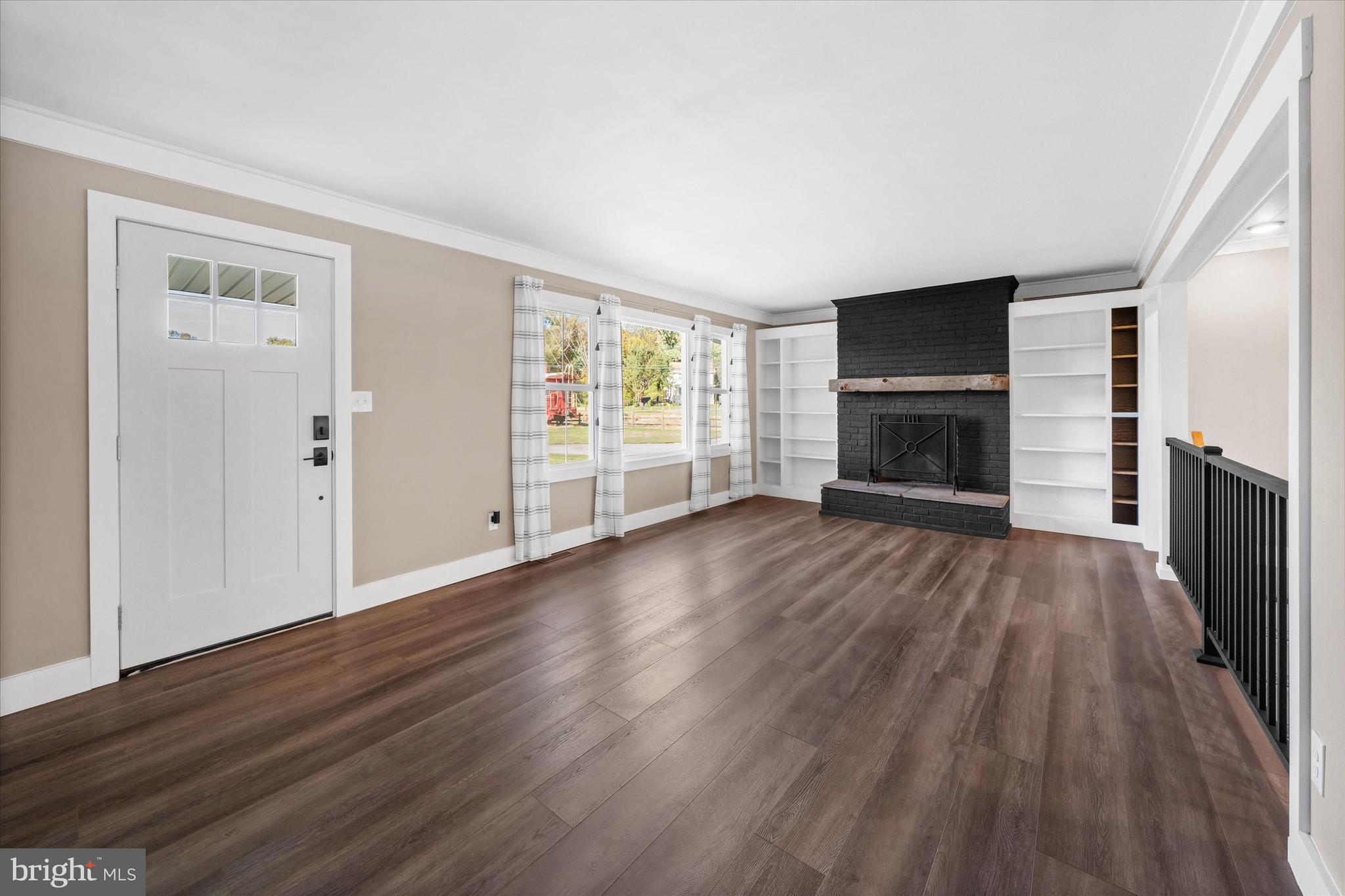 108 Evanson Road Hockessin, DE 19707 - Photo 4 of 49 wooden floor in an empty room with a fireplace
