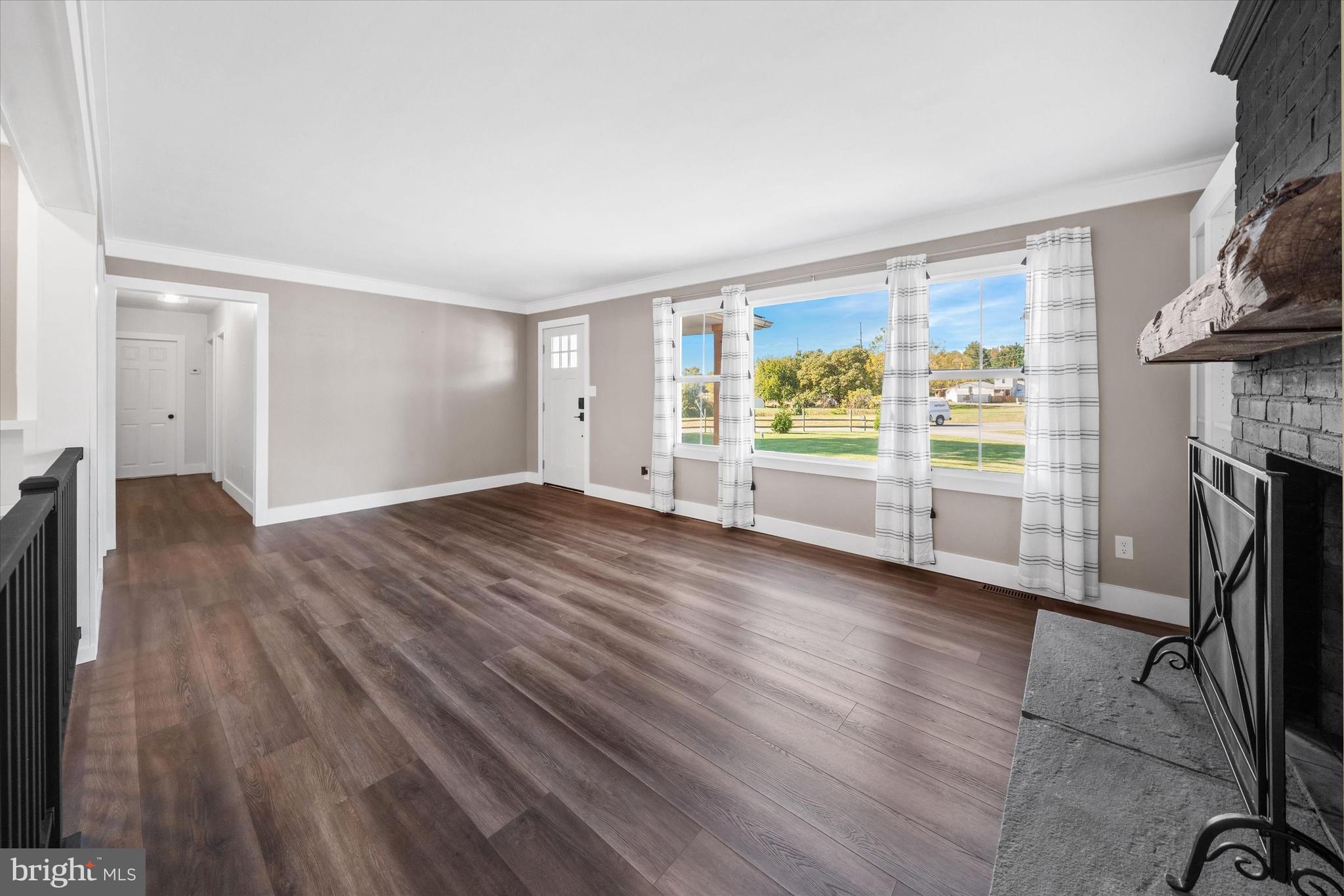 108 Evanson Road Hockessin, DE 19707 - Photo 5 of 49 wooden floor in an empty room with a fireplace