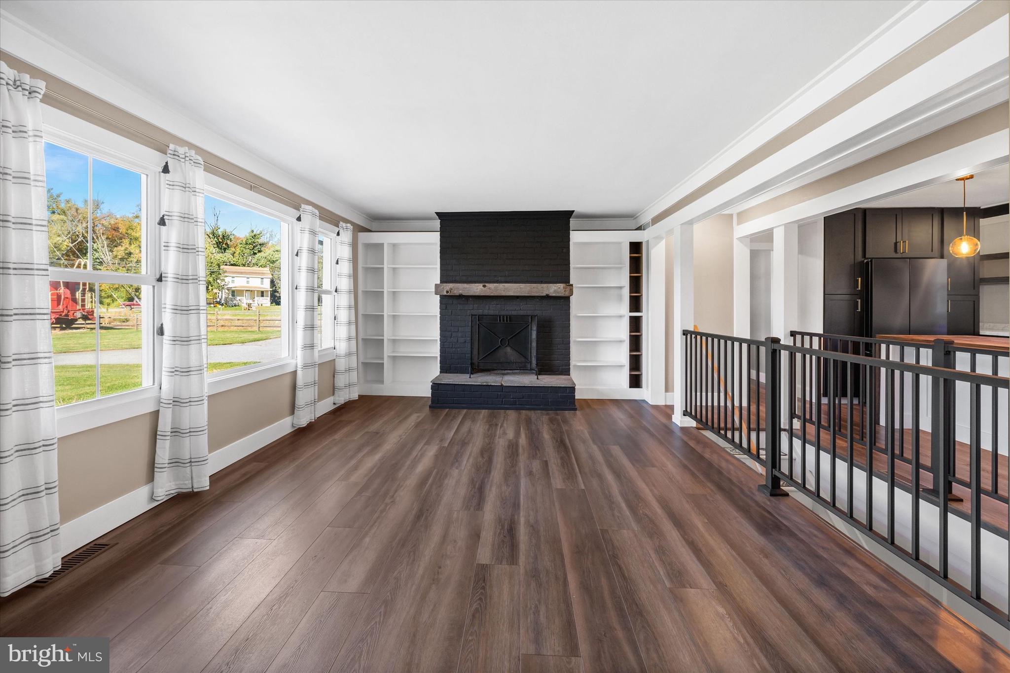 108 Evanson Road Hockessin, DE 19707 - Photo 6 of 49 a view of wooden floor fireplace and windows in an empty room
