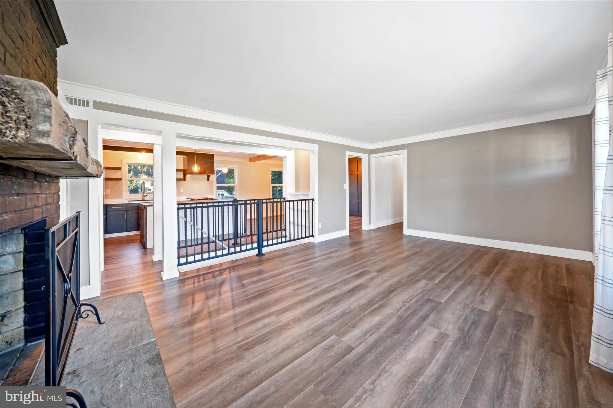 108 Evanson Road Hockessin, DE 19707 - Photo 9 of 49 wooden floor in an empty room with a fireplace